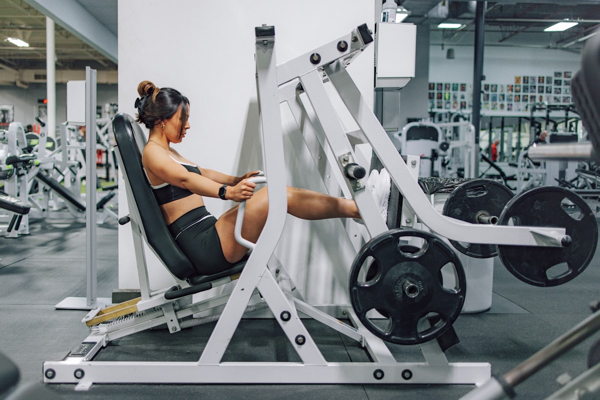Personal trainer with client performing strength training exercise